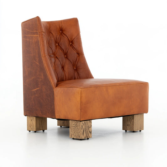 Thestudyandstool leather dining chair in cognac brown with plush upholstery and wooden legs, perfect for elegant dining rooms.